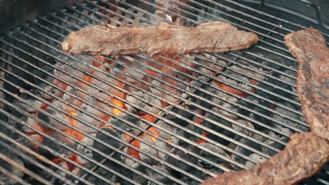 Close up of short ribs on grill cooking and being flipped with tongs Stock-Footage 256929311