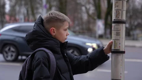 Close-up shot of 11 year old boy looking at the bus time table. Young boy Stock Footage 263449691