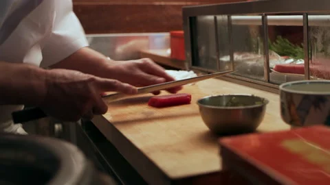 Close up shot on 4k RED camera. Professional male sushi chef slicing pieces of t Stock Footage 199457236