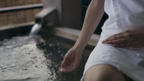 Close up shot on 4k RED camera. Peaceful Japanese woman sitting on ledge of hot Stock Footage 199458836