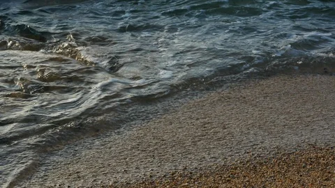 Close up shot from above of waves breaking on a rocky beach Stock Footage 111401188