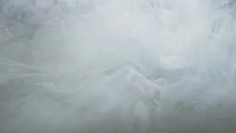 Close up shot of abstract white paint slowly dissolves in water Stock Footage 147314327
