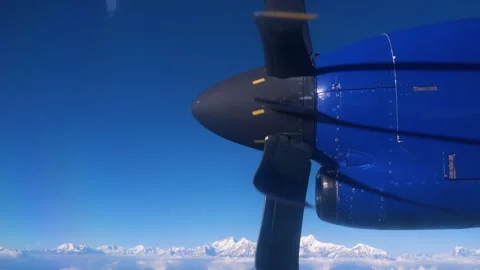 Close up shot of an airplane propeller and mountains, an aerial shot Stock Footage 281220190