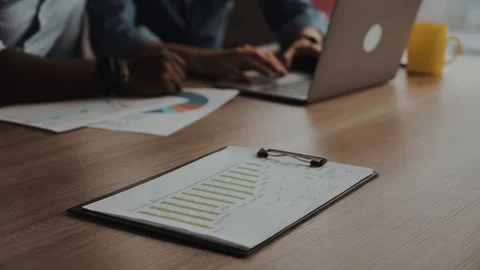 Close-up shot of an analytical working with the latest financial Stock Footage 99636799