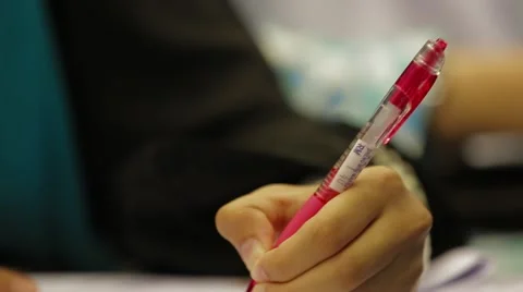 Close Up Shot and Rack Focus of Hands Holding A Pen and Writing Lecture Notes Stock Footage 49388675