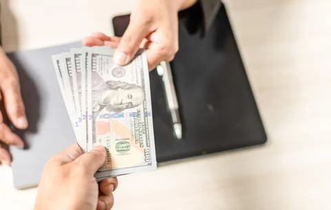 Close-up shot and select focus Concept of holding 100 dollar bills to buy a.. Stock Photos