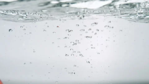 Close up shot of an apple falling in water Stock Footage 239012300