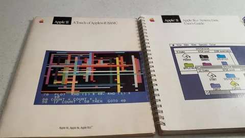 Close-up shot of Apple IIGS System Disk User's Guide, vintage Apple IIGS Stock Footage 122330349