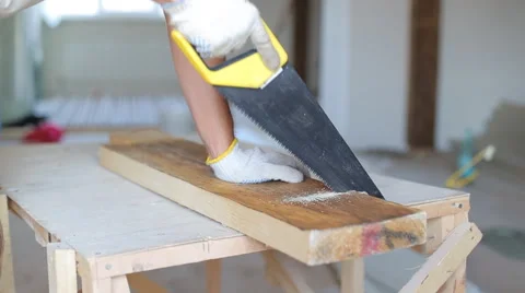 Close up shot of arms sawing through a wooden siding panel Stock Footage 67894635