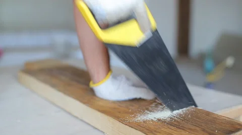 Close up shot of arms sawing through a wooden siding panel Stock Footage 67894790
