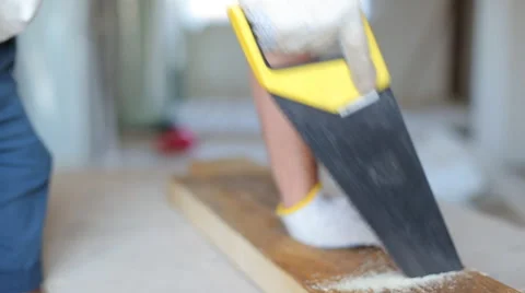 Close up shot of arms sawing through a wooden siding panel Stock Footage 67894869