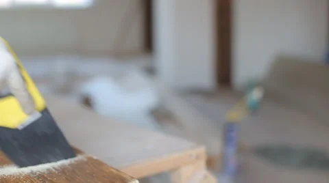 Close up shot of arms sawing through a wooden siding panel Stock Footage 67894976