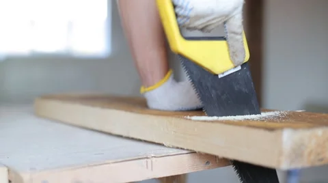Close up shot of arms sawing through a wooden siding panel Stock Footage 67895086