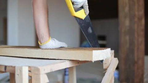 Close up shot of arms sawing through a wooden siding panel Stock Footage 67895198