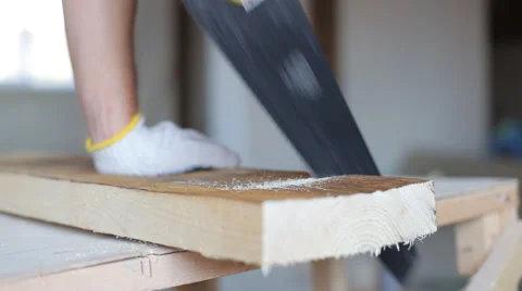 Close up shot of arms sawing through a wooden siding panel Stock Footage 67895458