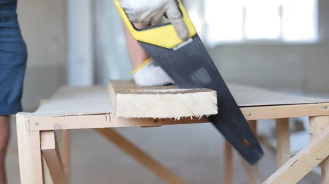 Close up shot of arms sawing through a wooden siding panel Stock Footage 67895534