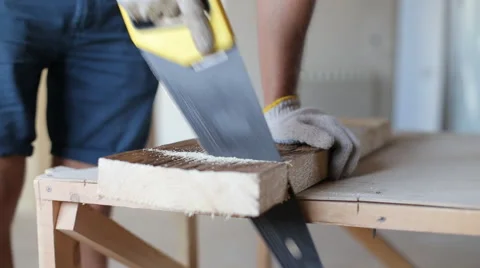 Close up shot of arms sawing through a wooden siding panel Stock Footage 67895749