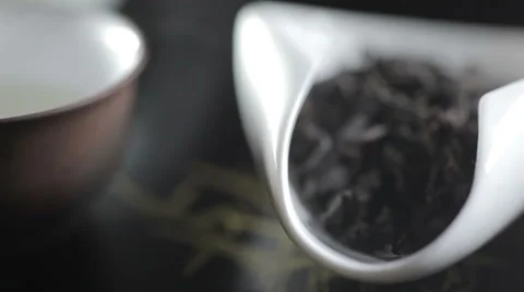 Close up shot of aromatic premium black tea leaves pile on white scoop Stock Footage 58304353
