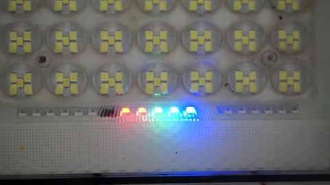 Close-up shot of an array of LED floodlight diodes featuring an active glowing 库存影片 344329239
