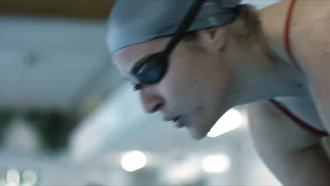 Close up shot of athlete swimmer preparing and jump into pool in slow motion Stock Footage 143568533