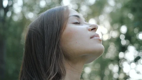 Close-up shot of an attractive smiling brunette girl with long hair, on which Stock Footage 124679088