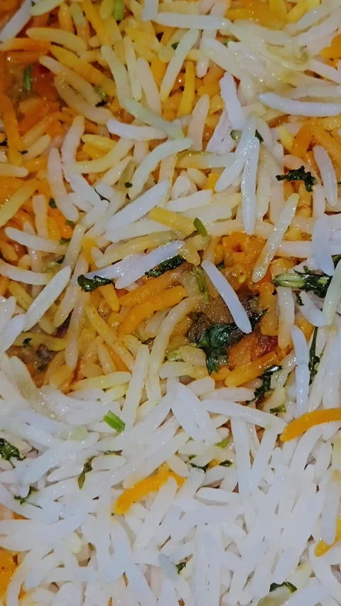 Close-up shot of authentic Indian biryani with long-grain basmati rice, saffron Stock Footage 340932703