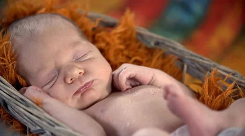 Close shot of baby with grumpy face laying in the basket Stock Footage 37189809