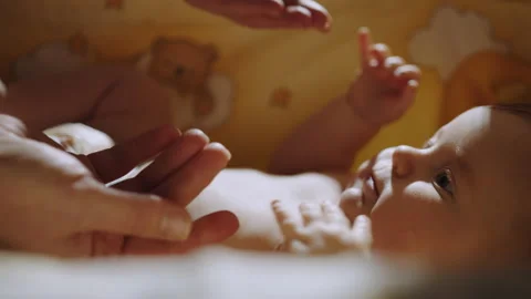 Close-up shot of baby's little hand reaching for father's loving finger. Baby Stock Footage 191107586