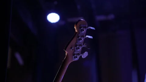 A close-up shot of the back of an bass guitar headstock Stock Footage 319480096
