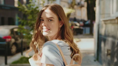 Close up shot back beautiful young woman turn looking at camera smiling joyfully Stock Footage 140969975