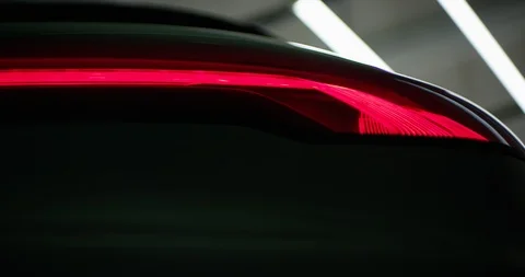 Close Up shot of the back lights and the wheels of a luxury car Stock Footage 126532400