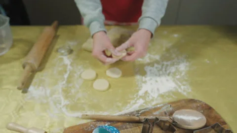 Close-up shot of a Baker cuts out cookies with molds from fresh dough at home Video stock 169248573
