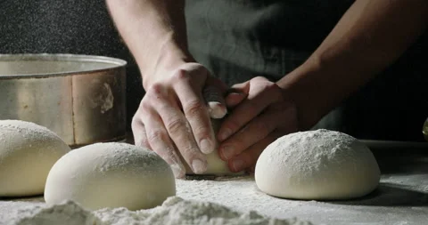 Close up shot of bakery worker carefuly forming loafs of bread. Baker making Stock Footage 161777119