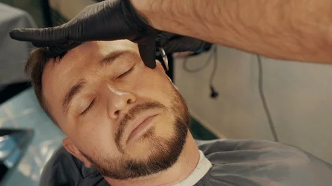Close up shot of barber shaving client with straight razor Stock Footage 125132235