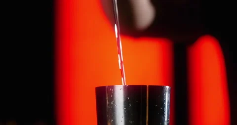 CLOSE UP SHOT: barman pours portion of transparent alcohol to the shaker in slow Stock Footage 156390248