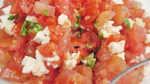 Close up shot of basil tomato salad with mozzarella stir with spoon Video stock 156207198