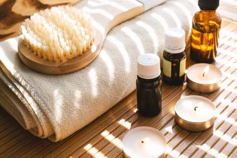 Close-up shot of bathing brush with essential oils and candles. SPA concept. Stock Photos