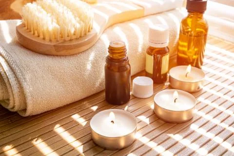 Close-up shot of bathing brush with essential oils and candles. SPA concept. 스톡 사진