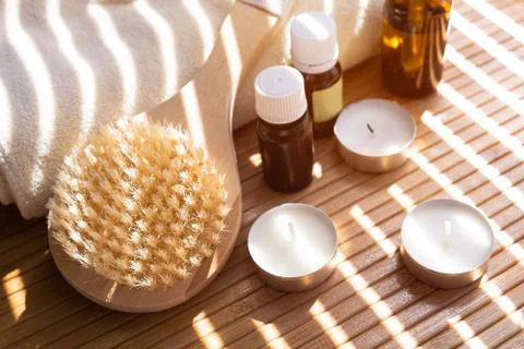 Close-up shot of bathing brush with essential oils and candles. SPA concept. Stock Photos