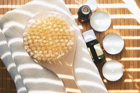 Close-up shot of bathing brush with essential oils and candles. SPA concept. Stock Photos