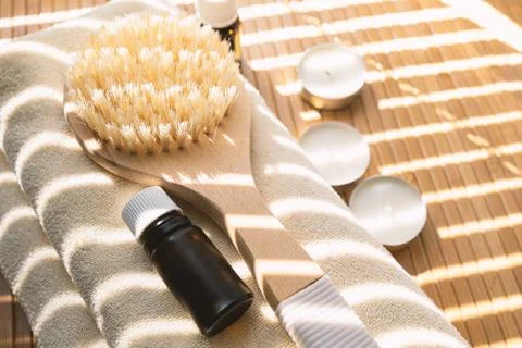Close-up shot of bathing brush with essential oils and candles. SPA concept. Stock Photos