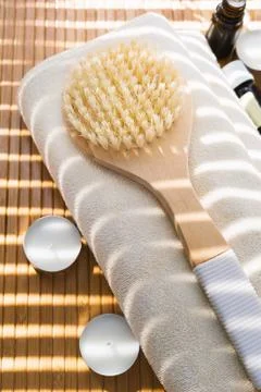 Close-up shot of bathing brush with essential oils and candles. SPA concept. Stock Photos