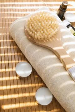 Close-up shot of bathing brush with essential oils and candles. SPA concept. Stock Photos