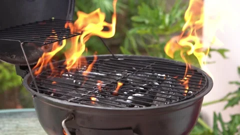 Close-up shot of a BBQ grill being prepared with open flames, charcoal heat Stock Footage 337891994