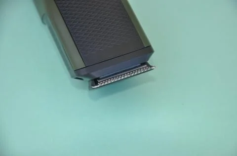 Close up shot of beard trimmer without comb isolated on green background.    Stock Photos
