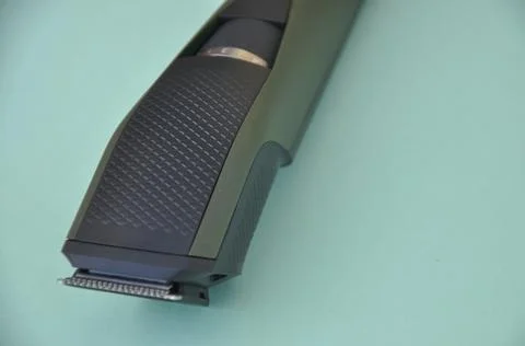 Close up shot of beard trimmer without comb isolated on green background.    Stock Photos