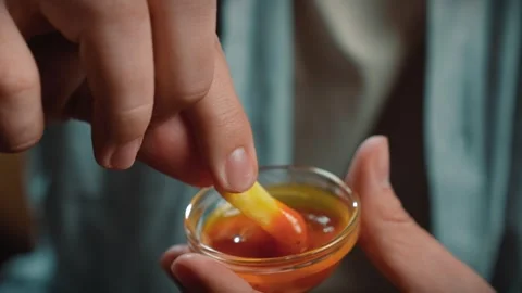 Close up shot of bearded man face, man holding and dipping fried potato in sauce Stock Footage 305495028