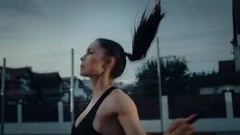 Close Up Shot of a Beautiful Busty Fitness Girl Skipping/Jumping