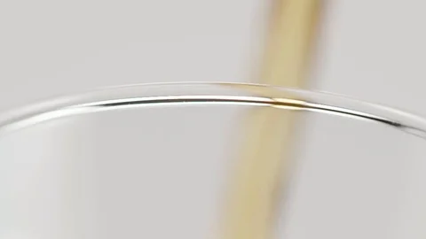Close up shot of a beer pour over the edge of a glass shot against a white cyc Stock Footage 70680544