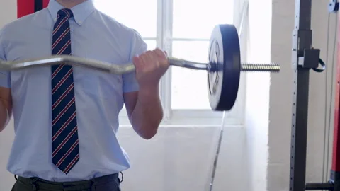 Close shot of biceps curl training: unrecognisable Man in suit lifting heavy Stock Footage 145540014